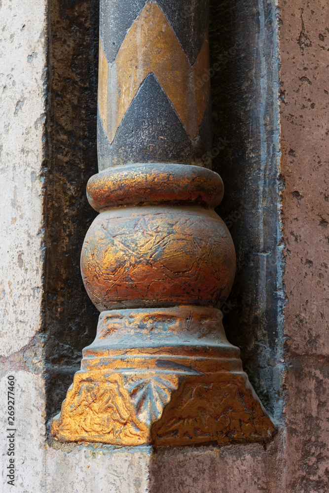 Golden base of a small decorative pillar (column) with engraved floral inscriptions at the ancient public mosque of Sultan Hassan, Old Cairo, Egypt Golden base of a small decorative pillar (column) with engraved floral inscriptions at the ancient public mosque of Sultan Hassan, Old Cairo, Egypt