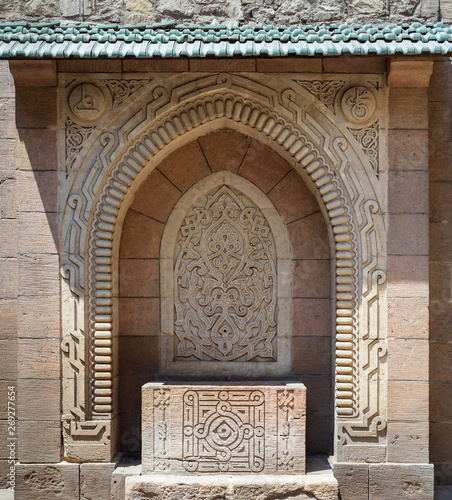 Stone sculpted drinking fountain (Sabil) with engraved floral decorations at the public garden of The Manial Palace of Prince Mohammed Ali Tewfik, Cairo, Egypt