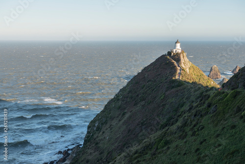 Lighthouse on Nugget Point in Otago, New Zealand photo