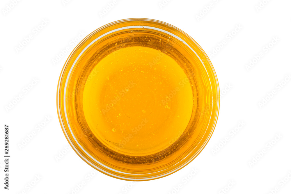 Honey in glass bowl isolated on white background Honey in glass bowl isolated on white background
