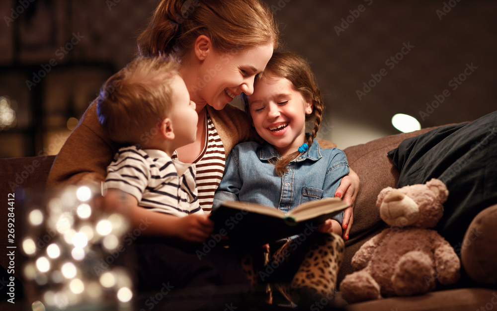 evening family reading. mother reads children . book before going to bed - obrazy, fototapety, plakaty 
