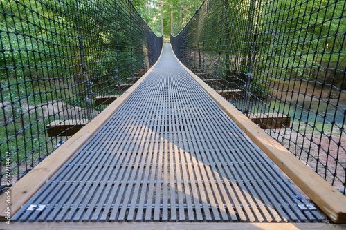 FORT MILL, SOUTH CAROLINA/UNITED STATES – APRIL 27, 2019: Suspension bridge at Anne Springs Close Greenway in Fort Mill, South Carolina.    