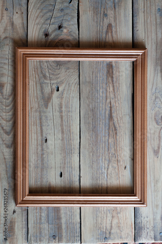 empty picture wooden frame on a wooden table top view