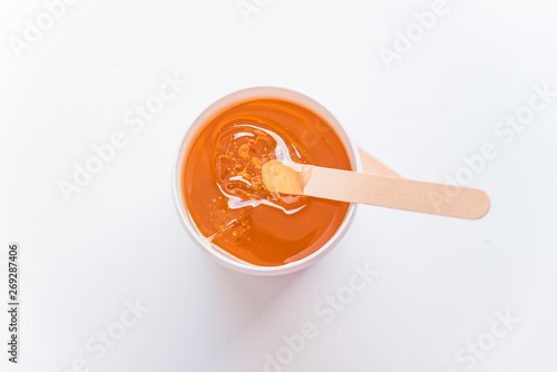 sugaring concept. flat lay. overhead view of bowl with cosmetology honey