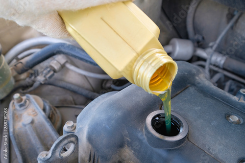 pouring engine oil into the engine