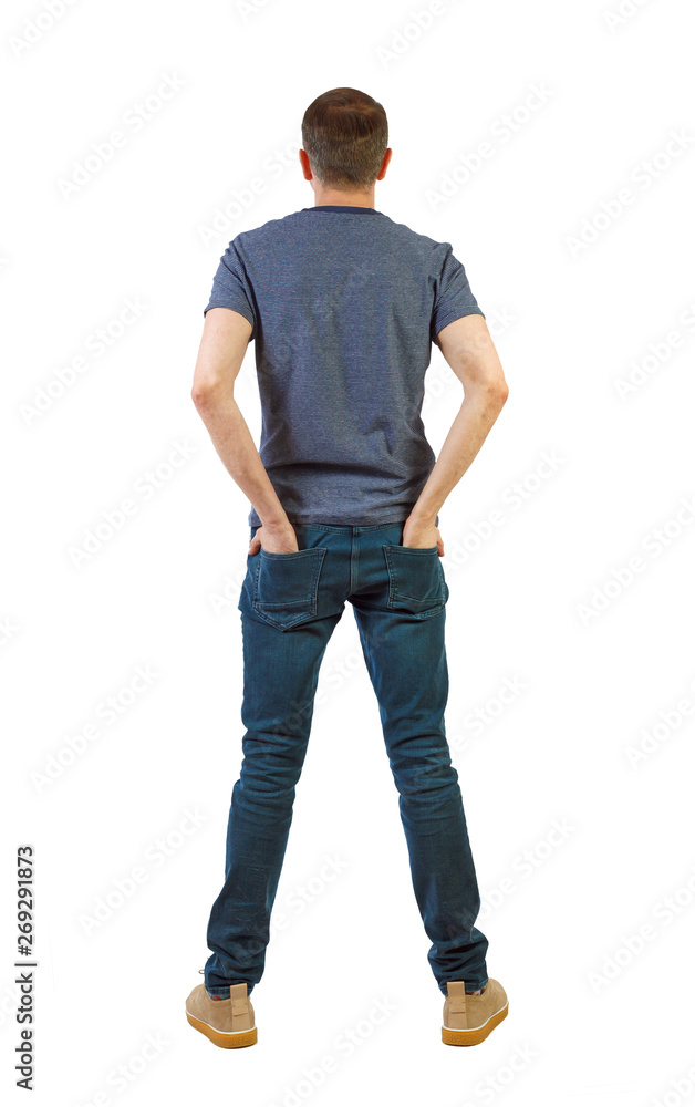 Back view of man in dark jeans. Standing young guy. Back view of man in dark jeans. Standing young guy.
