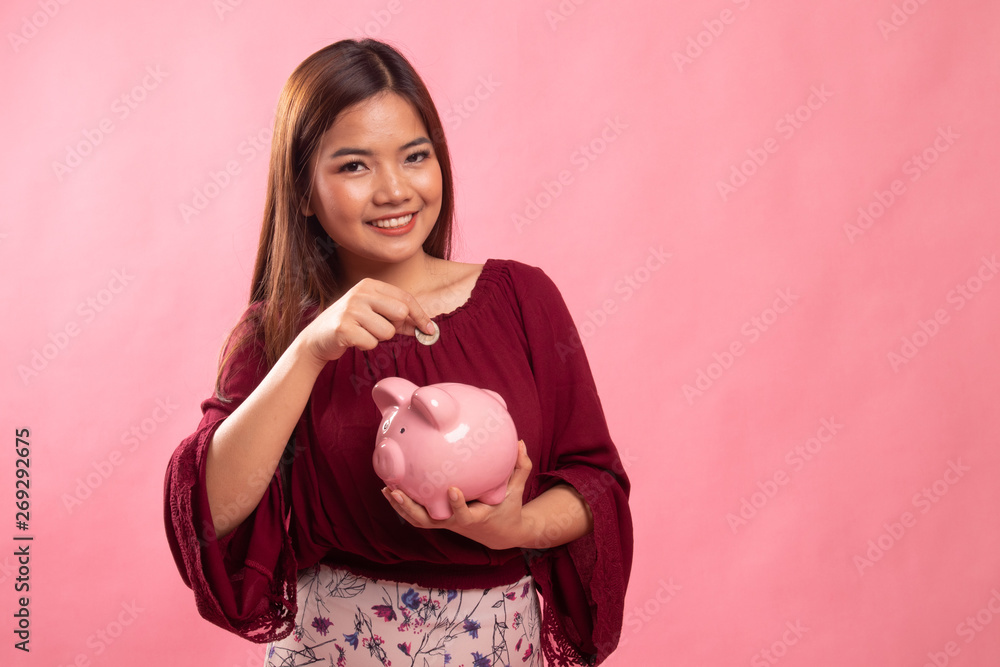 Asian woman with coin and pig coin bank. Asian woman with coin and pig coin bank.
