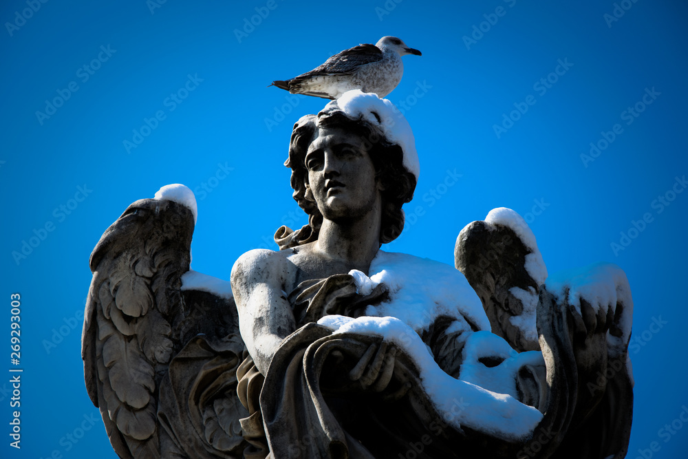 Fototapeta premium Angel statue in Rome - Italy - in winter with snow