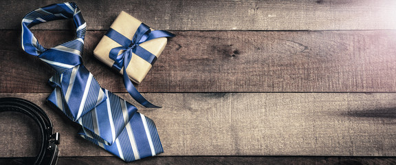 Tie Belt And Gift Box  On Wooden Table With Sunlight - Fathers Day Concept