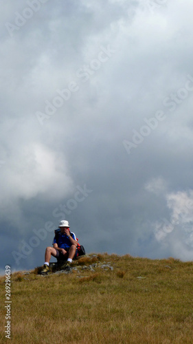 Boy hiking the mountains in search of freedom. Cold, misty weather