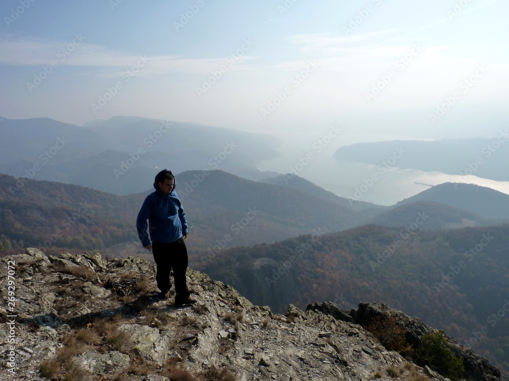 Boy hiking the mountains in search of freedom. Cold, misty weather