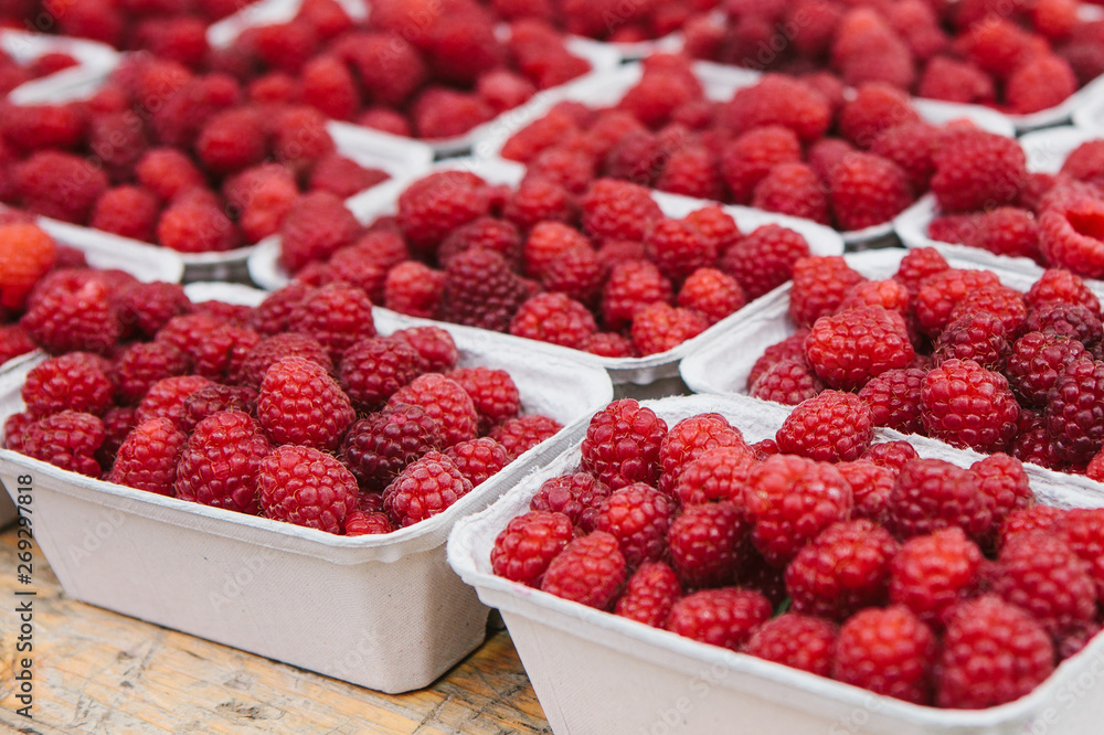 A lot of raspberries in containers. Useful food A lot of raspberries in containers. Useful food