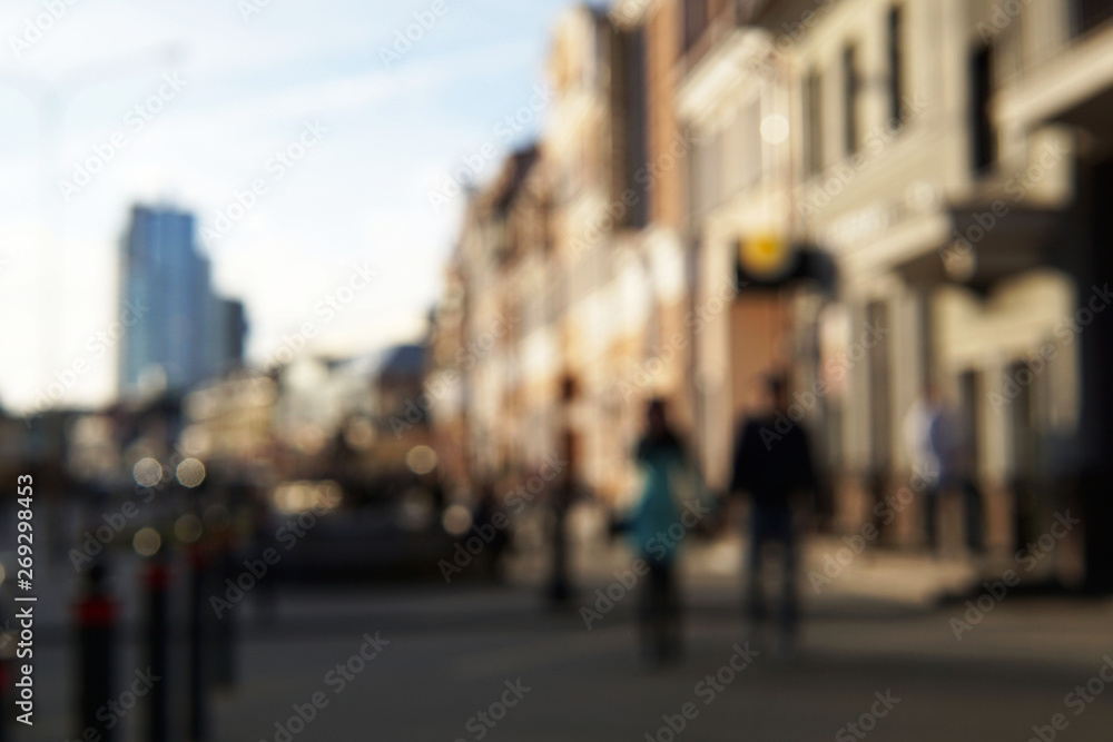 Couple of young people on the street with people and buildings on the background. Couple of young people on the street with people and buildings on the background.