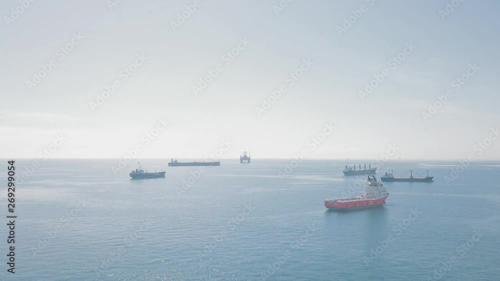 Various large ships in the sea next to the oil rig Various large ships in the sea next to the oil rig
