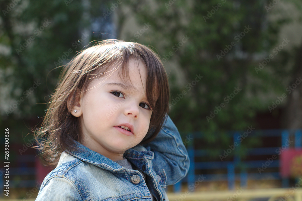 closeup portrait of little cute emotional girl with pigtails in a denim jacket closeup portrait of little cute emotional girl with pigtails in a denim jacket