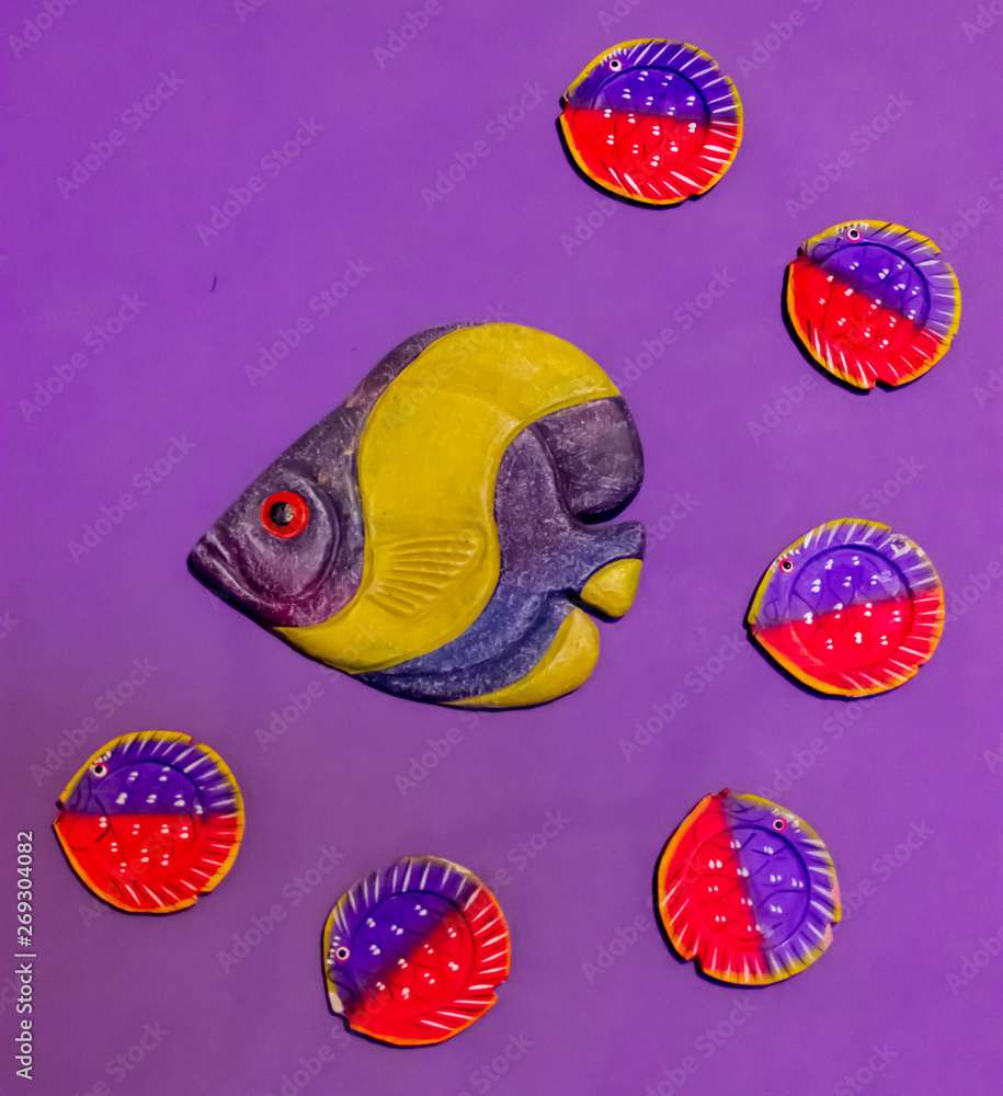 Purple background with goldfish decoration, made of clay with six colored leaves. Purple background with goldfish decoration, made of clay with six colored leaves.