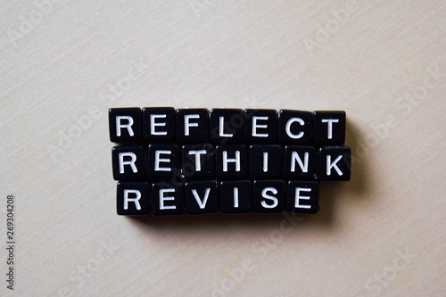 Reflect - Rethink - Revise on wooden blocks. Business and inspiration concept photo
