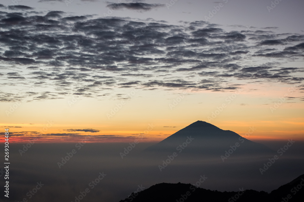 Warm morning sunrise on Ghober Hut campsite with view of mount Cikuray. Beautiful landscape of mount Papandayan. Papandayan Mountain is one of the favorite place to hike on Garut.