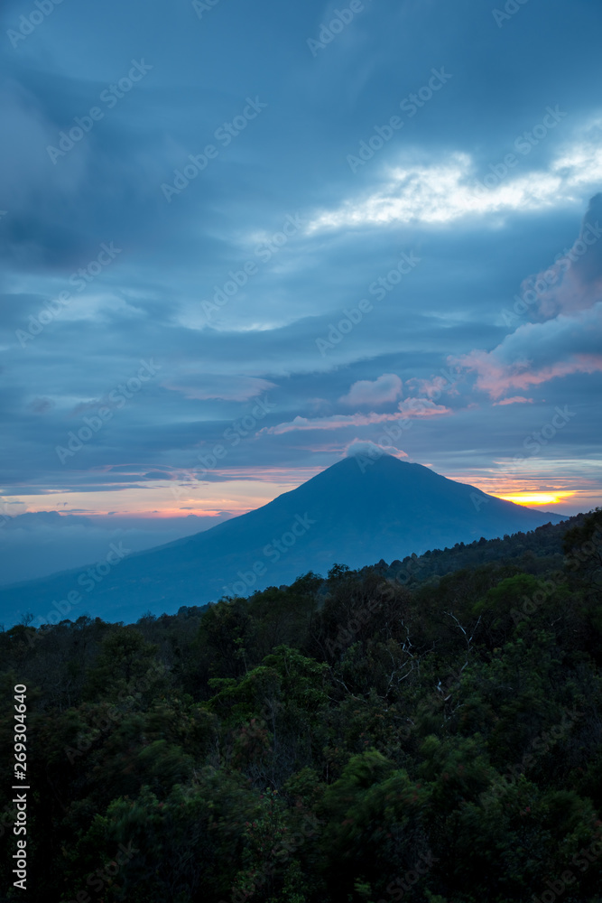Warm morning sunrise on watch tower with view of mount Cikuray. Beautiful landscape of mount Papandayan. Papandayan Mountain is one of the favorite place to hike on Garut.