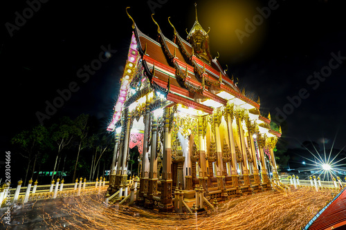 Shutter Bulbs image of Triple Circumambulation at the buddha church in night, People walking with candle light around buddha church of temple. Religion concept. Dark tone.