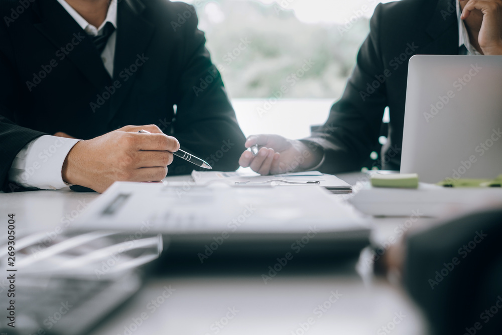 Business people analyzing investment graph meeting brainstorming and discussing plan in meeting room, investment concept Business people analyzing investment graph meeting brainstorming and discussing plan in meeting room, investment concept