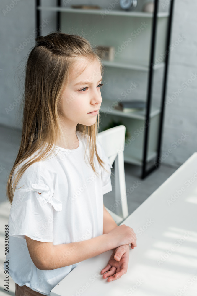 adorable kid in white t-shirt standing near table at home adorable kid in white t-shirt standing near table at home