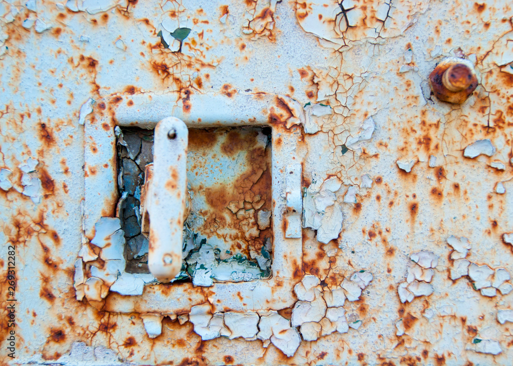 The lock on the old iron trailer - Old age, vintage, metal corrosion, layers of old peeling paint of different colors The lock on the old iron trailer - Old age, vintage, metal corrosion, layers of old peeling paint of different colors