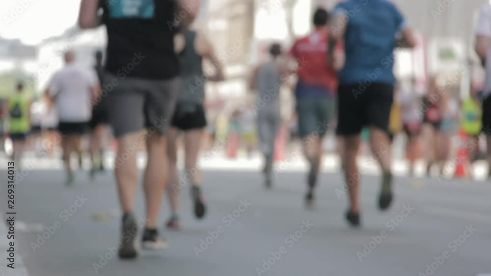 Marathon Runners Crowd Bottom-view Legs. Athletes Runing Out Off Focuss. Blurred Runner Feet Running Marathon. Marathon Runners Crowd Bottom-view Legs. Athletes Runing Out Off Focuss. Blurred Runner Feet Running Marathon.