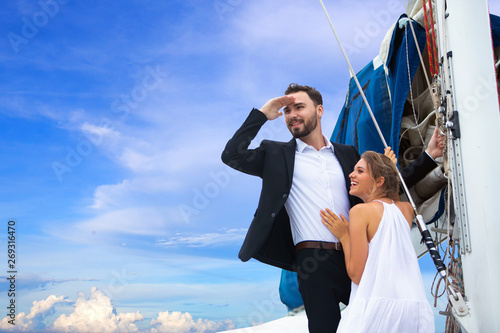 luxury business couple travelers Standing on the roof of the boat Yacht and showing their love for each other. Concept business travel © NVB Stocker