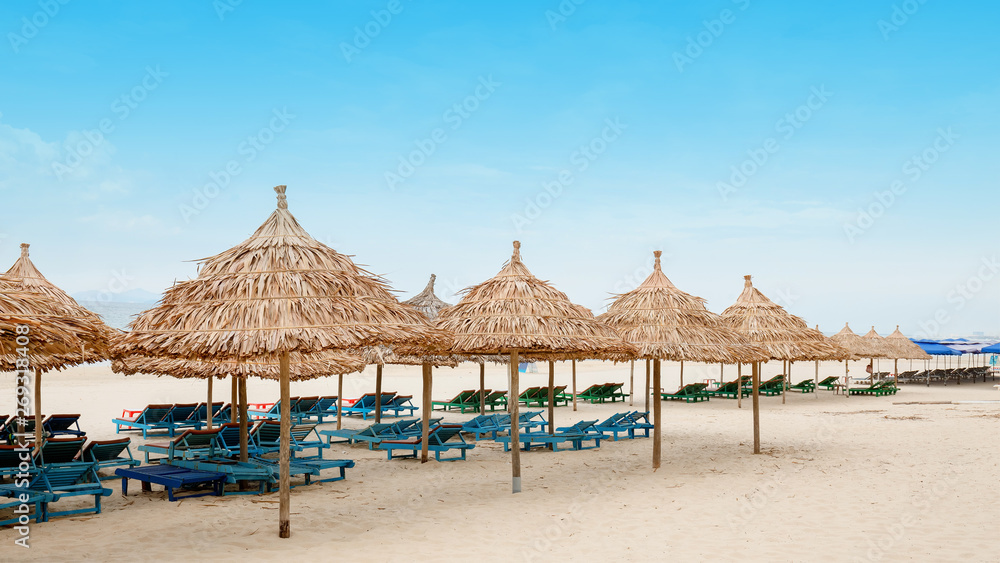 White sand beach with relaxing chairs