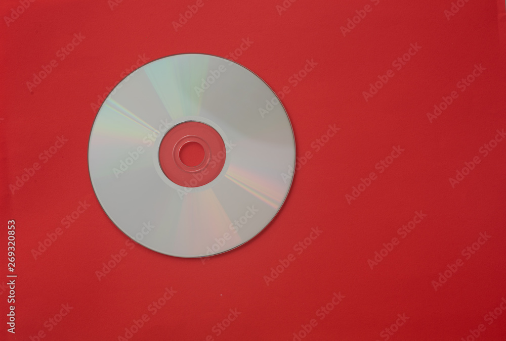 Compact disc isolated against red background Compact disc isolated against red background