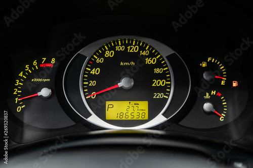 Foto Сlose-up of the car  black interior:  dashboard, speedometer and tachometer with green backlight and other buttons