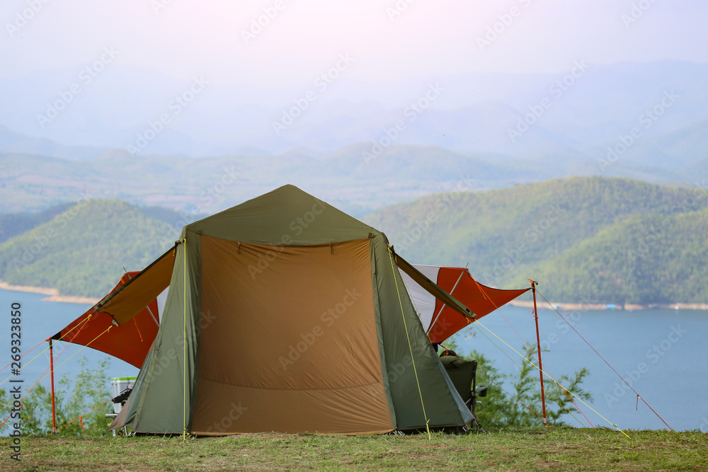 Top hill camping area on the forest camping site near lake. Camping tent on hill of high mountain summer landscape relax. Top hill camping area on the forest camping site near lake. Camping tent on hill of high mountain summer landscape relax.