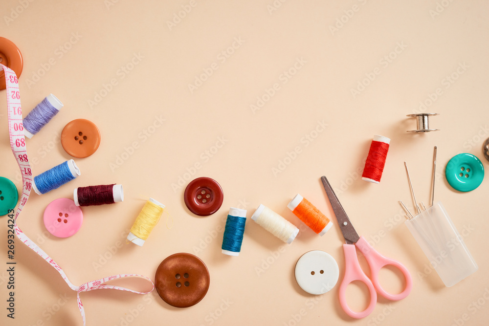 tools for needlework thread scissors and tape measure isolated on biege background tools for needlework thread scissors and tape measure isolated on biege background