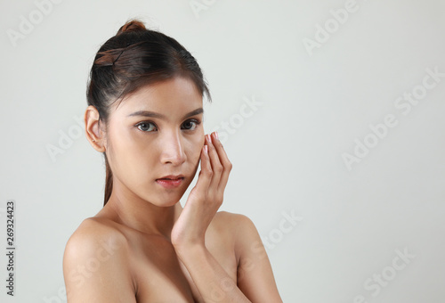 Beauty portrait of female face with natural skin. Beautiful woman face close up portrait young studio on gray.