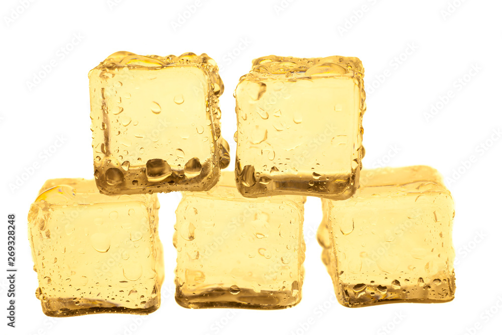 Golden ice cubes on white background.