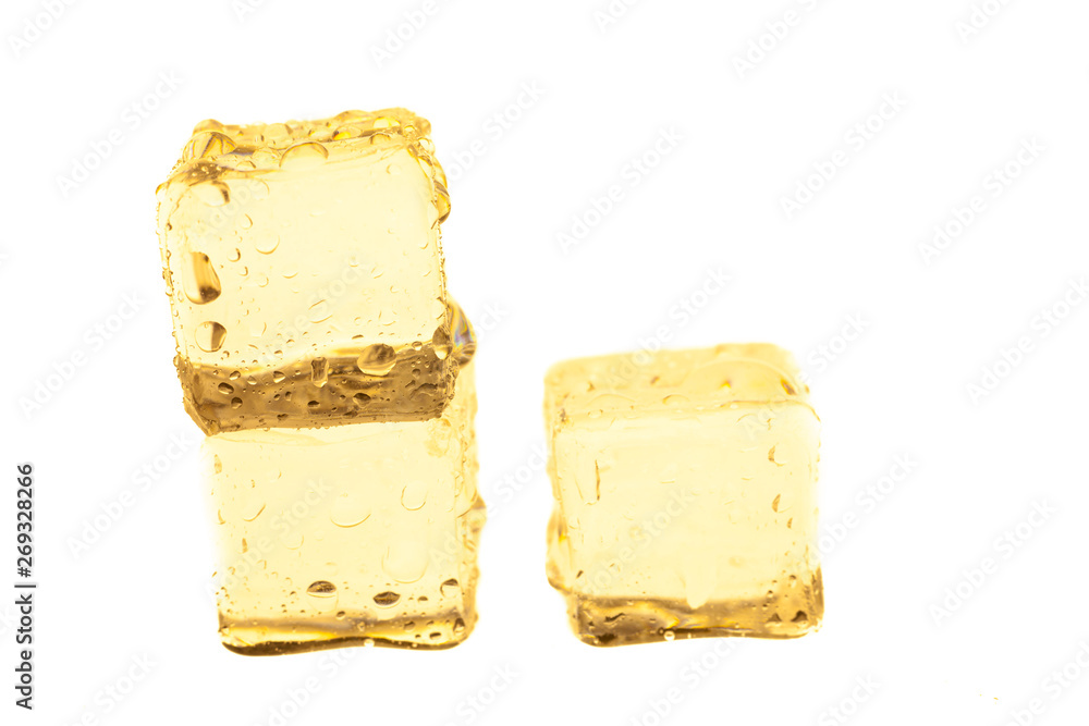 Golden ice cubes on white background.