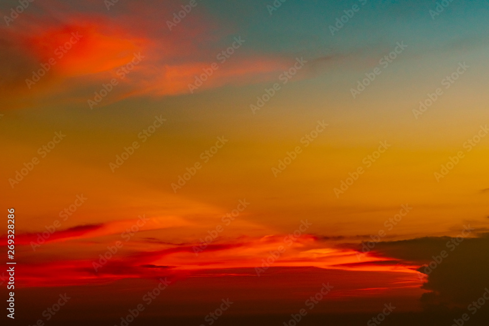 Dramatic red and orange sky and clouds abstract background. Red-orange clouds on sunset sky. Warm weather background. Art picture of sky at dusk. Sunset abstract background. Dusk and dawn concept