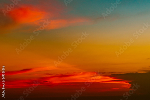 Dramatic red and orange sky and clouds abstract background. Red-orange clouds on sunset sky. Warm weather background. Art picture of sky at dusk. Sunset abstract background. Dusk and dawn concept © Artinun