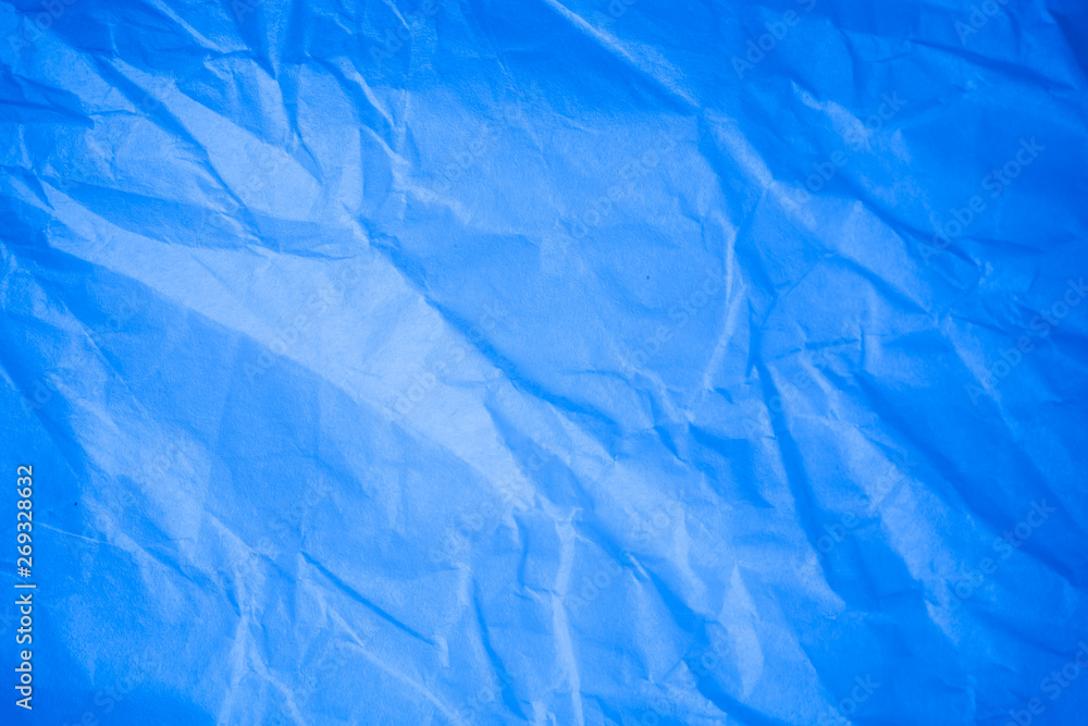 Obraz premium Crumpled blue paper background.