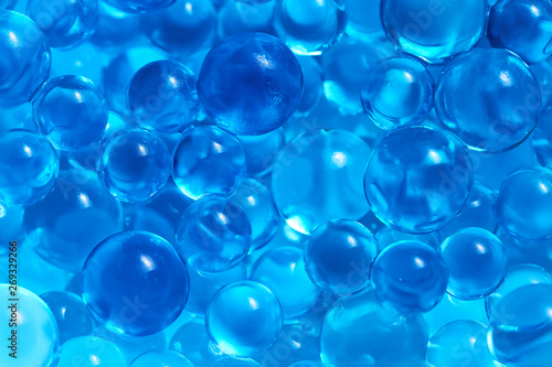 Water blue gel balls. Polymer gel. Silica gel. Balls of blue hydrogel. Crystal liquid ball with reflection. Texture background. Close up macro