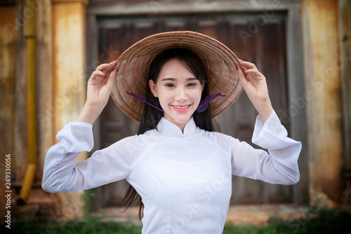 Beautiful woman with Vietnam culture traditional dress, Ao dai, in old resident © ittipol