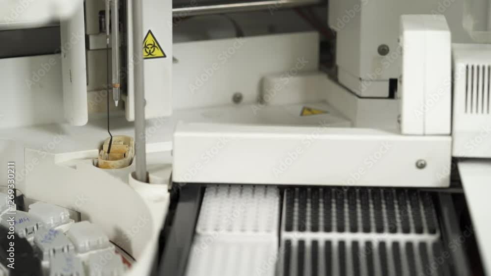 A close-up of automated chemistry analyzing process in medical laboratory. Professional medical equipment. Healthcare concept. Human biological samples analyzing A close-up of automated chemistry analyzing process in medical laboratory. Professional medical equipment. Healthcare concept. Human biological samples analyzing