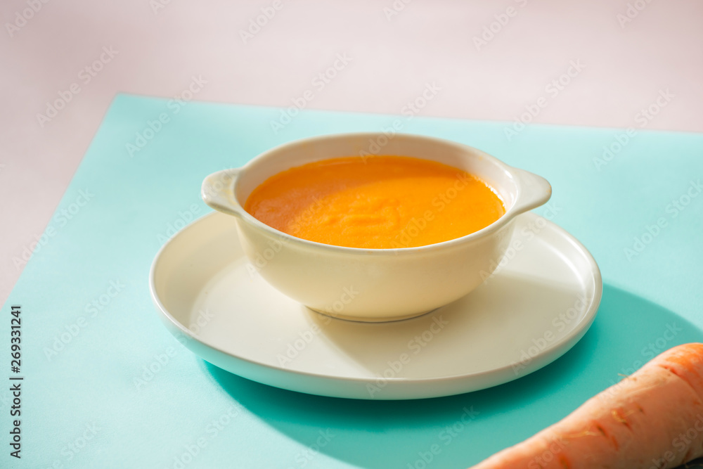 Carrot baby puree in bowl isolated on light background Carrot baby puree in bowl isolated on light background