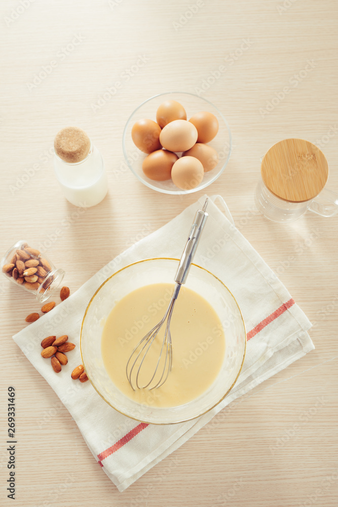 recipe ingredients : eggs, flour, milk, almonds, banana on white background recipe ingredients : eggs, flour, milk, almonds, banana on white background