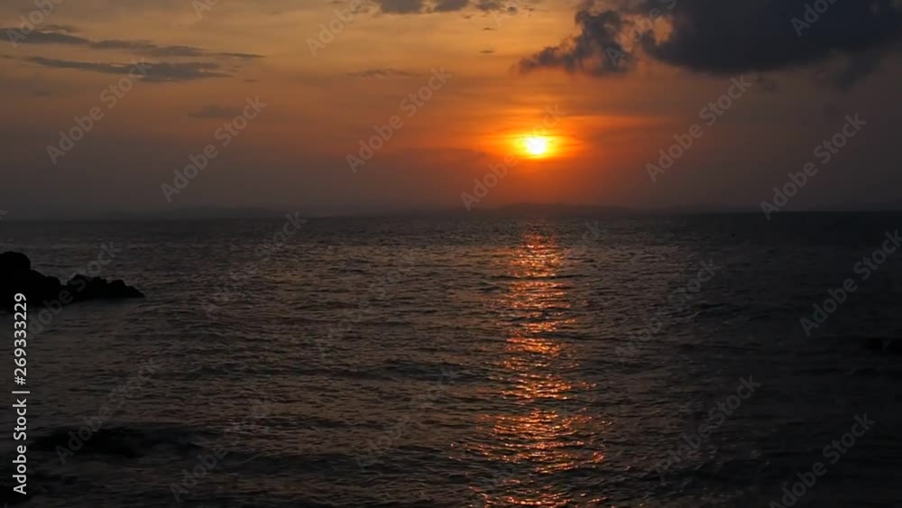 The sun emerged from the clouds in the sky and sea wave in the ocean gentle moving to the beach; landscape nature background concept The sun emerged from the clouds in the sky and sea wave in the ocean gentle moving to the beach; landscape nature background concept