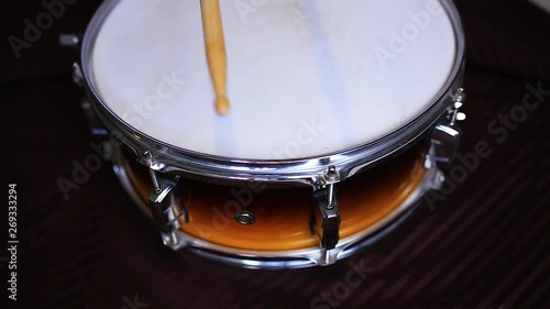 Drum and sticks. Drumsticks hitting the rim. Rim shot play.