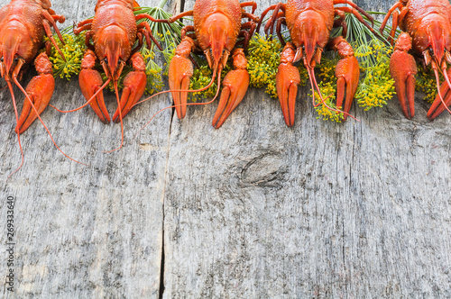Boiled crawfish on a wooden background. Top view