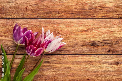 Fototapeta Naklejka Na Ścianę i Meble -  Bright spring bouquet of colorful tulips on wooden background