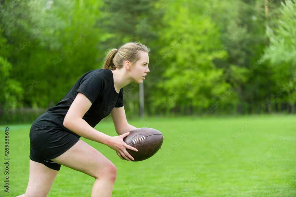 Girl playing rugby together outside in summer